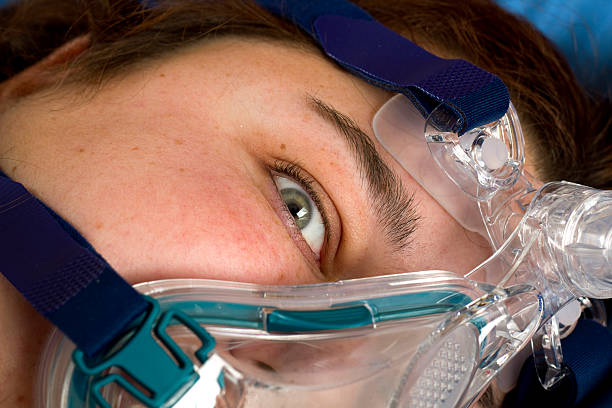 Woman wearing a full face Cpap mask.